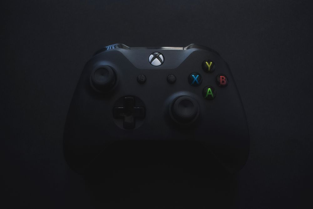 Black game controller photographed in low light